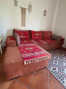 a living room with a red couch and a rug at Mel&Laranja in Alvor +29 photos