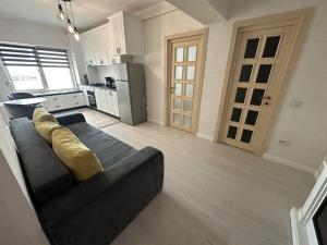 a living room with a couch and a kitchen at Fancy Bonjour - modern apartment in Iaşi
