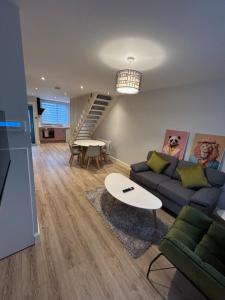 a living room with a couch and a table at Colony Retreat in Dingle