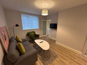 a living room with a couch and a table at Colony Retreat in Dingle
