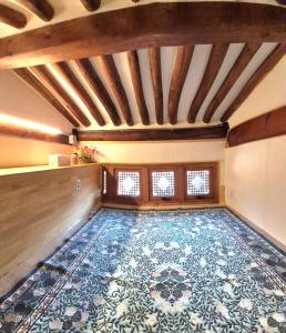 an empty room with a large rug on the floor at Authentic Leedo Hanok in Seoul