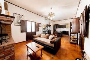 a living room with a couch and a table at Villa Oasis in Torre Lapillo