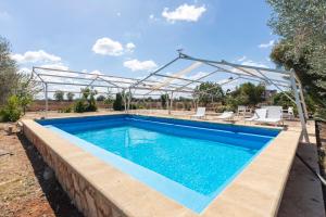 a swimming pool with a metal frame around it at Villa Oasis in Torre Lapillo