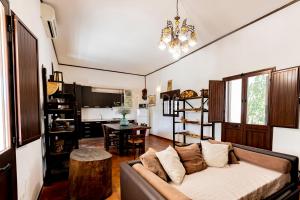 a living room with a couch and a table at Villa Oasis in Torre Lapillo +42 photos