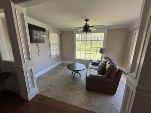 a living room with a couch and a table at Lux Minimum 2 Lexington With Riverwalk & CAE in West Columbia