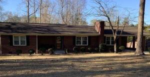 a red brick house with a tree in front of it at Lux Minimum 2 Lexington With Riverwalk & CAE in West Columbia
