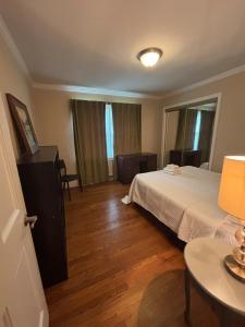 a bedroom with a bed and a table with a lamp at Lux Minimum 2 Lexington With Riverwalk & CAE in West Columbia