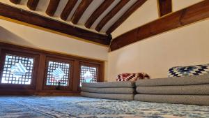 a living room with a couch and two windows at Authentic Leedo Hanok in Seoul
