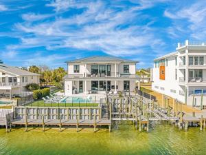 a house on the water with a dock at Isle Be Back in Destin