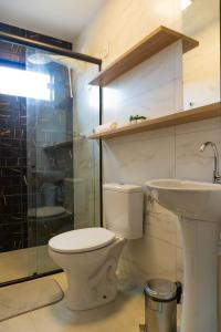 a bathroom with a toilet and a sink at Bananeiras Solar in Bananeiras +67 photos