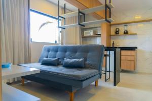 a blue couch in a living room with a table at Bananeiras Solar in Bananeiras