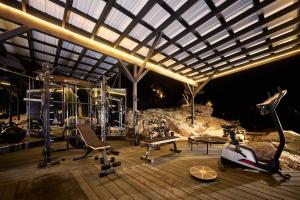 a gym with exercise equipment on a wooden deck at Paradise Ranch Inn - Ecstatic Tent in Three Rivers