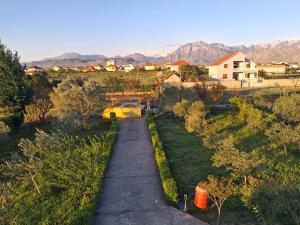 a walkway through a yard with mountains in the background at Villa Elezi in Culaj