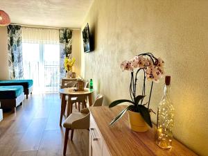 a kitchen and living room with a vase with a flower in it at Winnica Nad Jarem in Sandomierz
