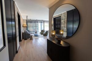 a living room with a large mirror on the wall at At Home Alonso in Santiago +86 photos