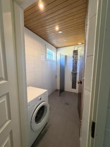 a laundry room with a washer and dryer in it at Apartment Koivikkotie in Savonlinna +3 photos
