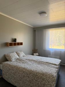 a bedroom with a large bed and a window at Apartment Koivikkotie in Savonlinna
