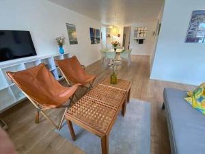 a living room with chairs and a table and a tv at 20334-Samso-Kaerbakken-13 in Hårdmark +4 photos
