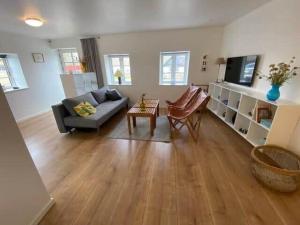 a living room with a couch and a tv at 20334-Samso-Kaerbakken-13 in Hårdmark