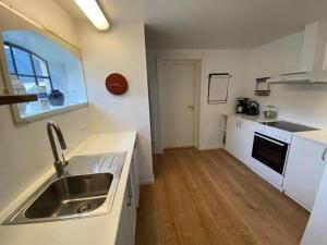 a kitchen with a sink and a counter top at 20334-Samso-Kaerbakken-13 in Hårdmark