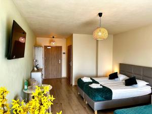 a hotel room with a bed and a living room at Winnica Nad Jarem in Sandomierz