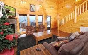 a living room with a christmas tree in a cabin at Lovely Platog Chalet with jacuzzi in Morzine