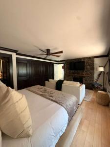 a bedroom with a large white bed with a ceiling fan at Spacious 3 & 3 in Aspen's Core with Sauna in Aspen