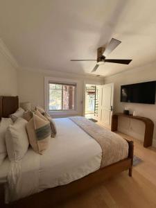 a bedroom with a large bed with a ceiling fan at Spacious 3 & 3 in Aspen's Core with Sauna in Aspen