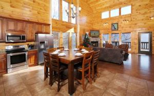 a kitchen and dining room with a table and chairs at Lovely Platog Chalet with jacuzzi in Morzine