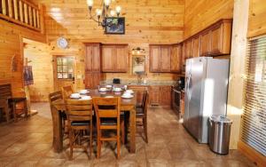a kitchen with a table and a refrigerator at Lovely Platog Chalet with jacuzzi in Morzine +30 photos