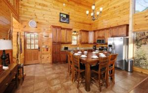 a dining room with a table and a kitchen at Lovely Platog Chalet with jacuzzi in Morzine