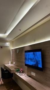 a room with a large flat screen tv on a wall at Bee Home Stay in Greater Noida