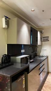 a kitchen with a sink and a counter top at Bee Home Stay in Greater Noida