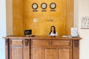 a woman standing behind a counter with clocks on the wall at Сонячна Квітка in Polyana +98 photos