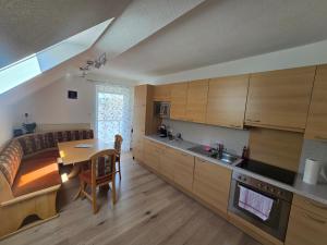 a kitchen and living room with a table and a couch at Ferienwohnung U28 in Ferlach