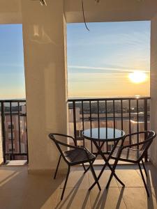 a table and chairs on a balcony with a view at FIN Skyline Apartment in Krujë