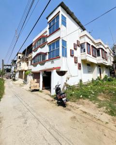 a motorcycle parked in front of a building at The Tulsi Enclave Riverside in Agartala