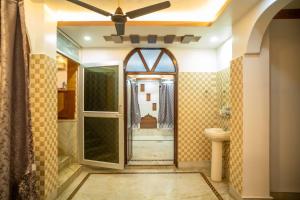 a bathroom with a ceiling fan and a mirror at The Tulsi Enclave Riverside in Agartala +26 photos