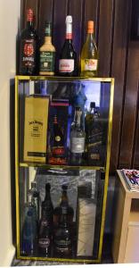 a refrigerator filled with lots of bottles of alcohol at Skye Palace Apartment - Ambassador Suite in Akure +15 photos