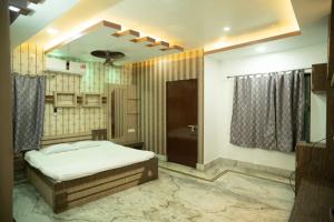 a bedroom with a bed and a bathroom at The Tulsi Enclave Riverside in Agartala