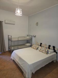 a bedroom with a bed and two bunk beds at Nostra casa rooms in Palermo