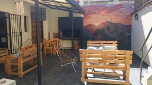 a room with a table and chairs and a painting at MillaUno Hostel in Córdoba
