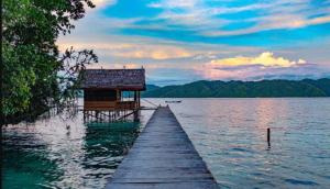 a dock with a house on top of the water at Mantorom homestay in Yennanas Besir