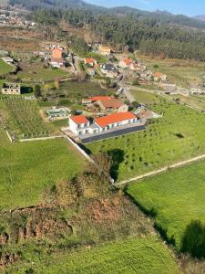 an aerial view of a house in a field at Olivo de Reis in Caldas de Reis