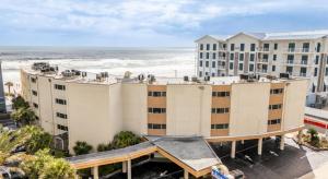 an aerial view of a hotel with the ocean in the background at Outrigger Beach Club Resort by CoolVacay in Ormond Beach