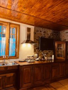 a kitchen with a sink and a tv on the wall at Nautica Bahna in Orşova +41 photos