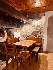 a dining room with a wooden table and chairs at Nautica Bahna in Orşova