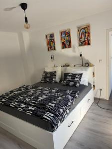 a bedroom with a large bed with black and white sheets at Ferienwohnung Nora in Vordernberg