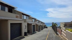 a row of buildings on a street with the ocean at Beach Bliss Retreat in Margate