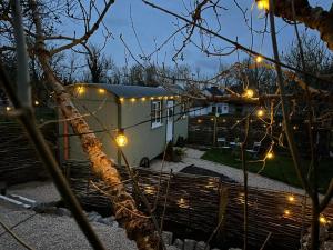 a trailer parked in a yard with lights on it at Shepherds Hut Galway in Galway